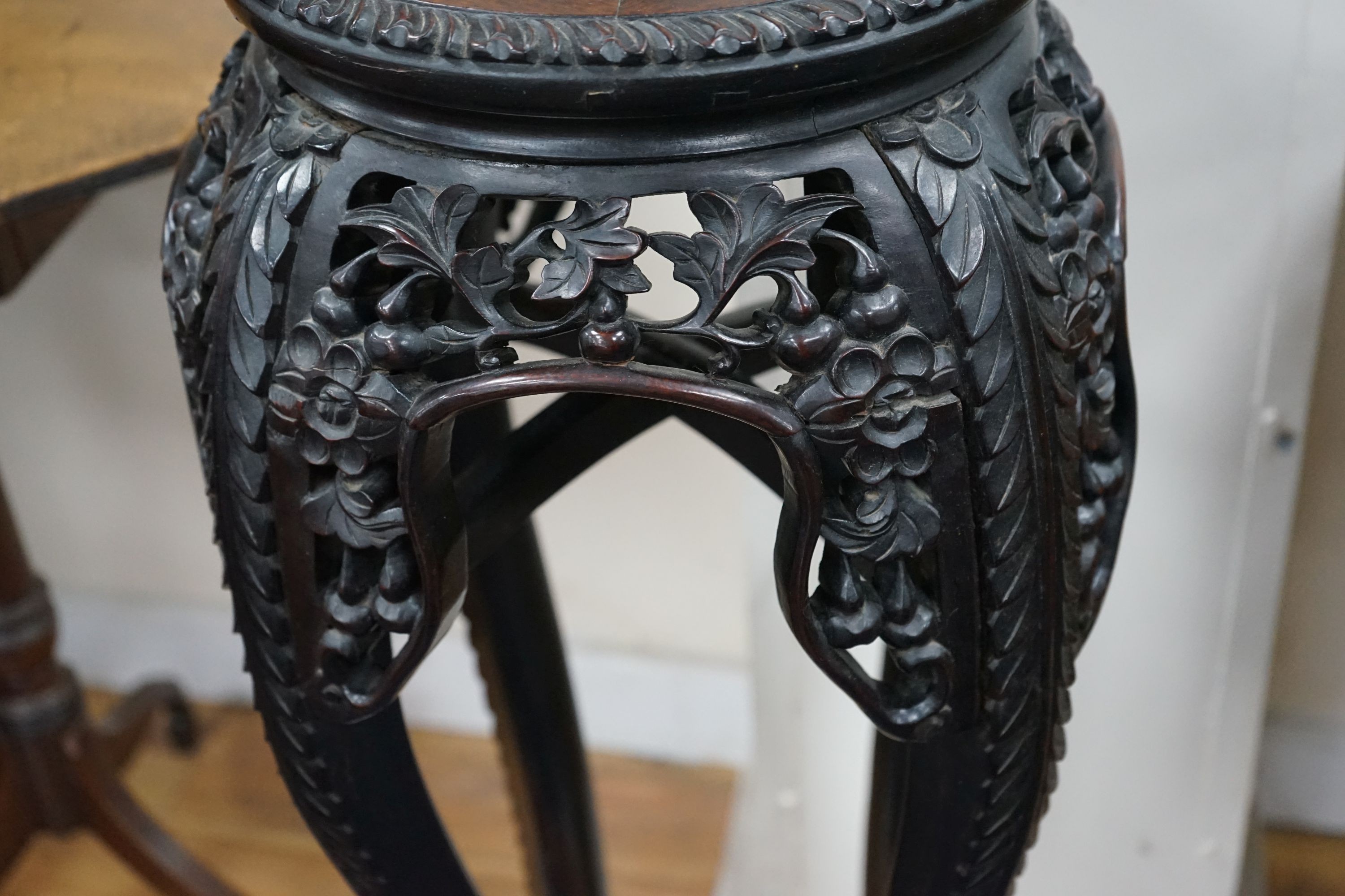 A Chinese circular marble top carved padouk jardiniere stand, height 91cm